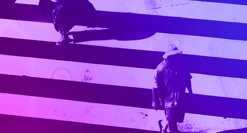Two people on a zebra crossing with blue to purple colour hue.
