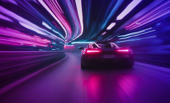 High-performance sports car zooming round a corner in a tunnel of motion blurred neon lights