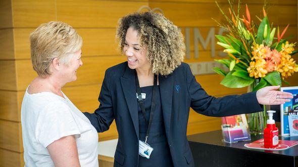 Hospital admin chatting with patient.