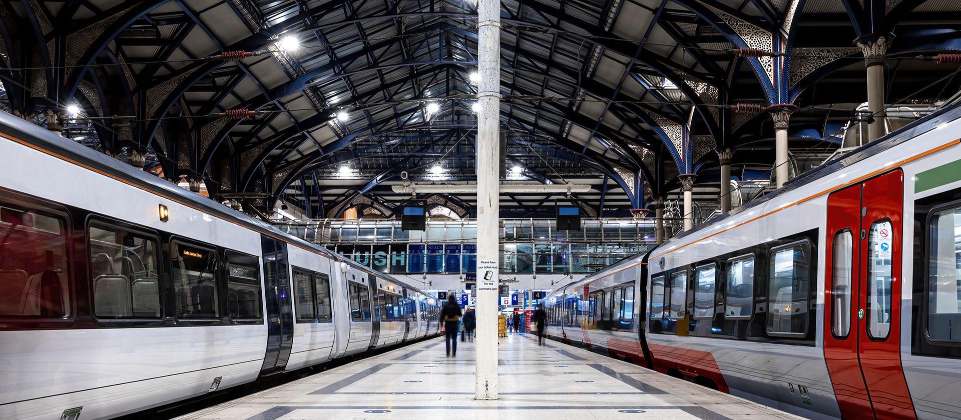 Two trains from a low viewing angle in a rail station.