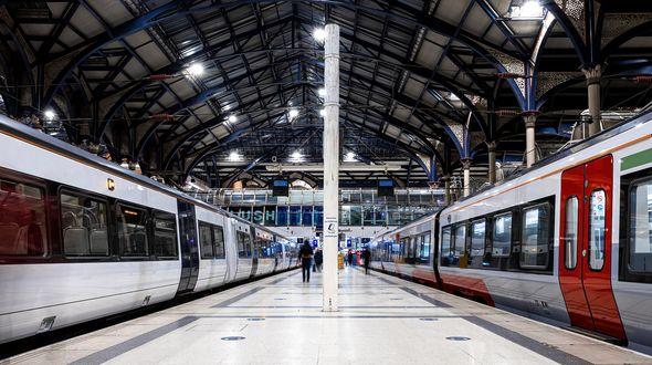 Two trains from a low viewing angle in a rail station.