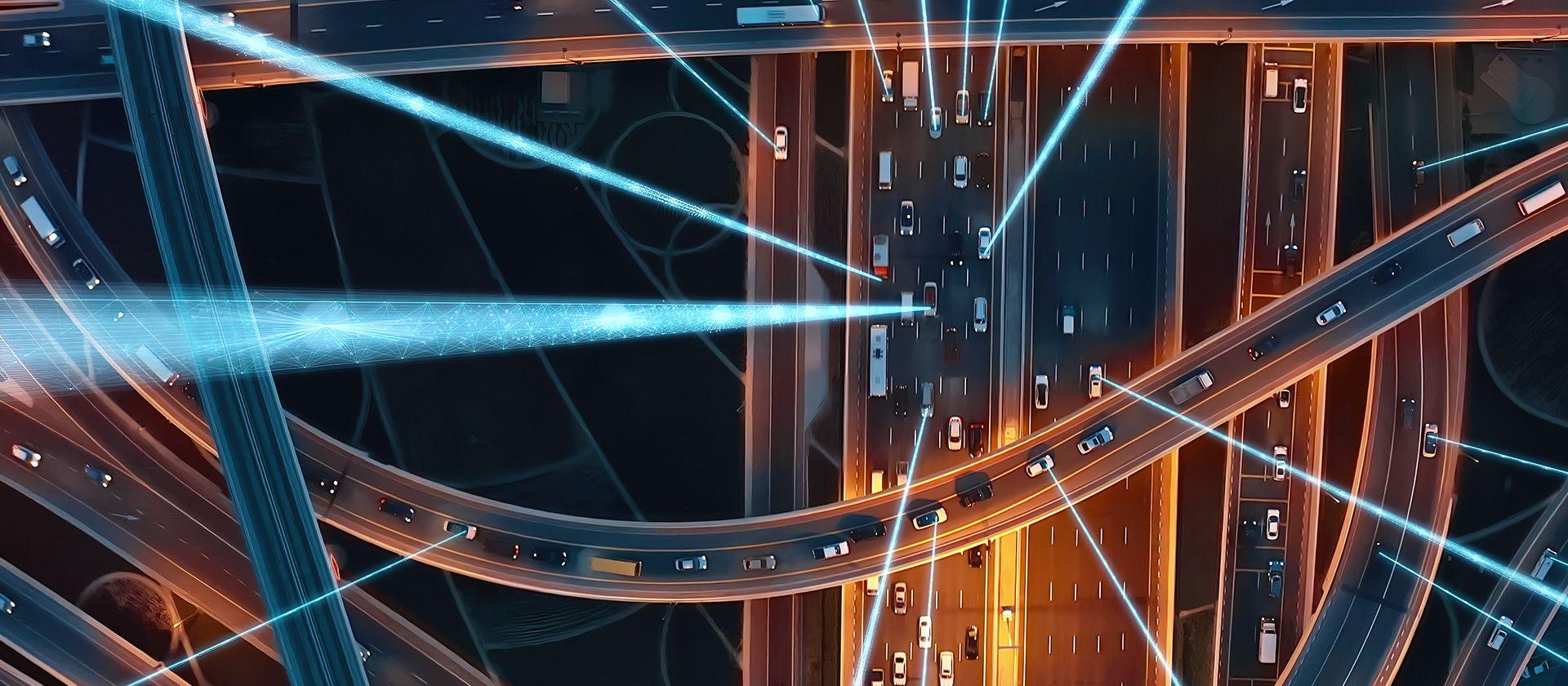 Birds-eye view of motorway at night with abstract graphic to signify connections and data.