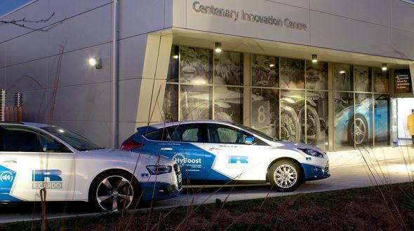 Two Ricardo branded cars infront of an innovation centre.