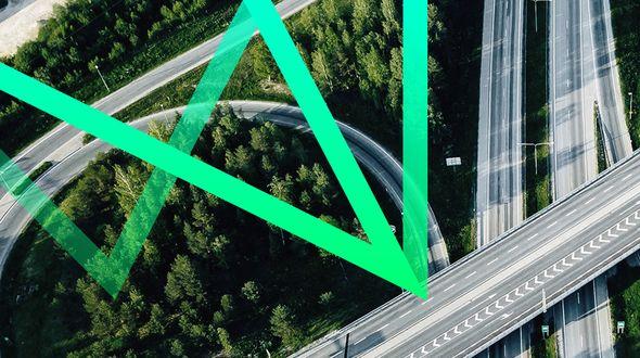 Birds-eye view of motorway with a green abstract graphic overlayed.